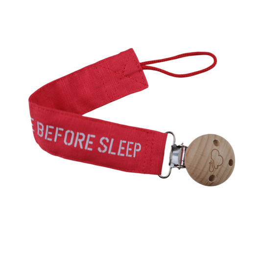 Red Remove Before Sleep baby pacifier clip, strap and clasp close-up