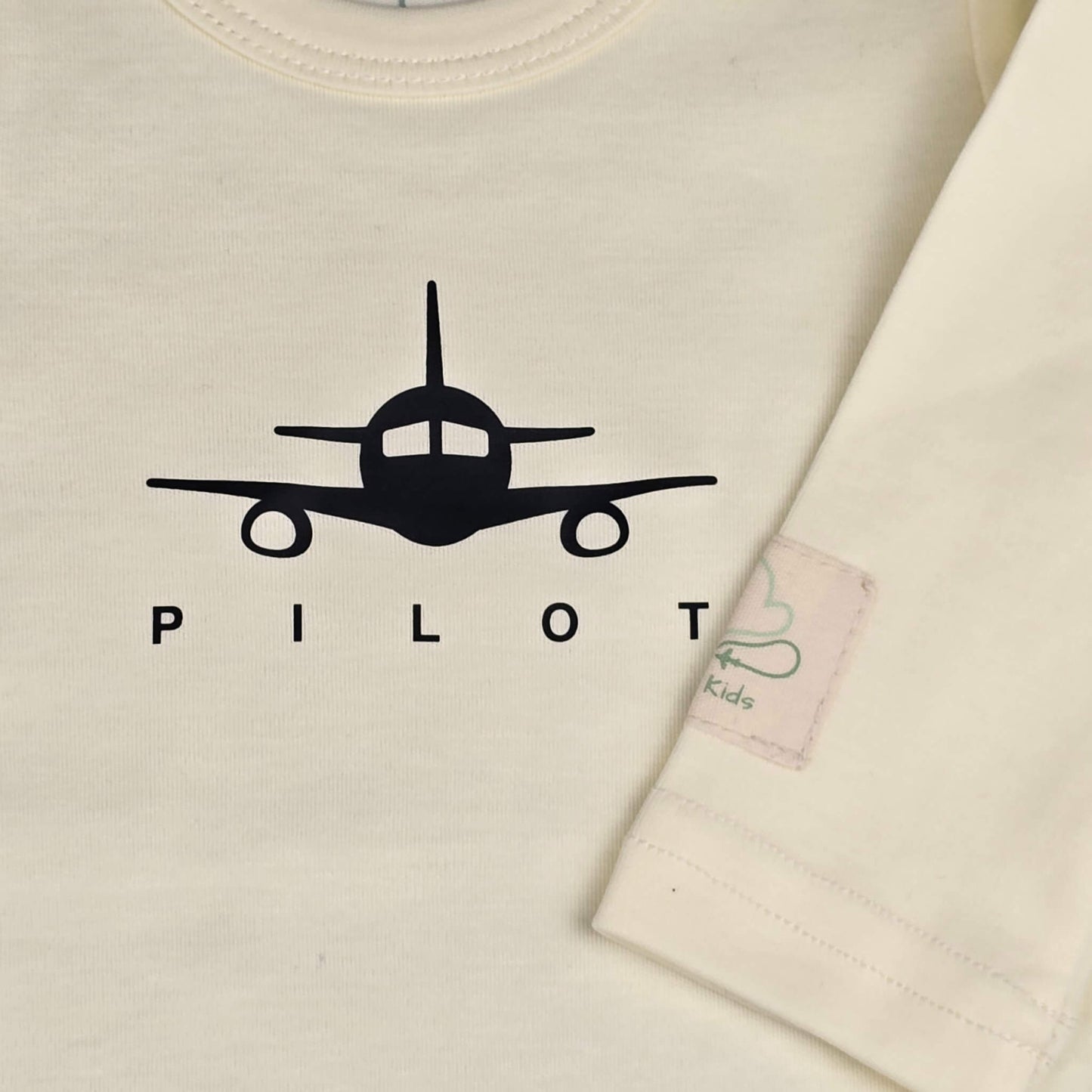 Beige aviation baby bodysuit, front airplane print close-up