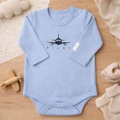 Steel blue long sleeve baby bodysuit with PILOT graphic, lifestyle view – Kumy Kids