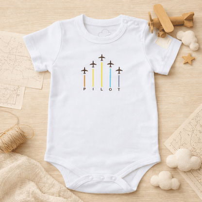 White short sleeve baby bodysuit with ARROWS graphic, lifestyle view – Kumy Kids