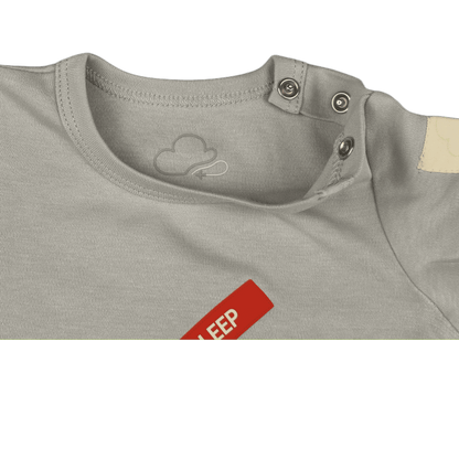 Grey Remove Before Sleep baby onesie, neckline and snap detail