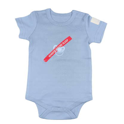 Steel blue baby onesie with a red and white label recalling remove before flight